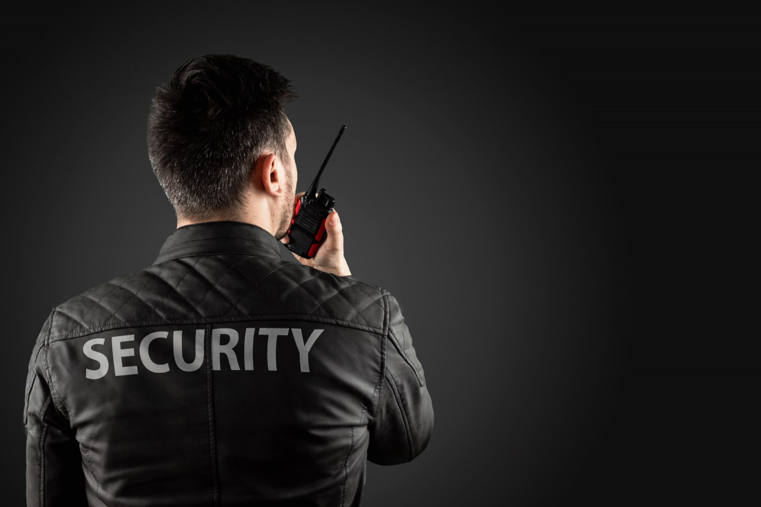 man-security-is-holding-walkie-talkie-min Man Security Is Holding Walkie Talkie Min